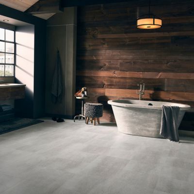 bathroom design with tile floors and wood accent wall